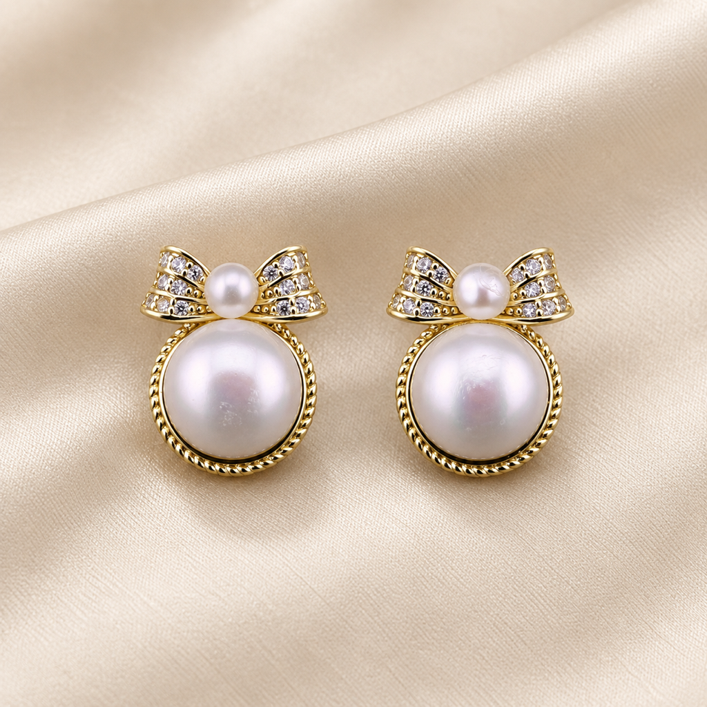 VEEKISSY bow freshwater pearl stud earrings, pair on ivory fabric