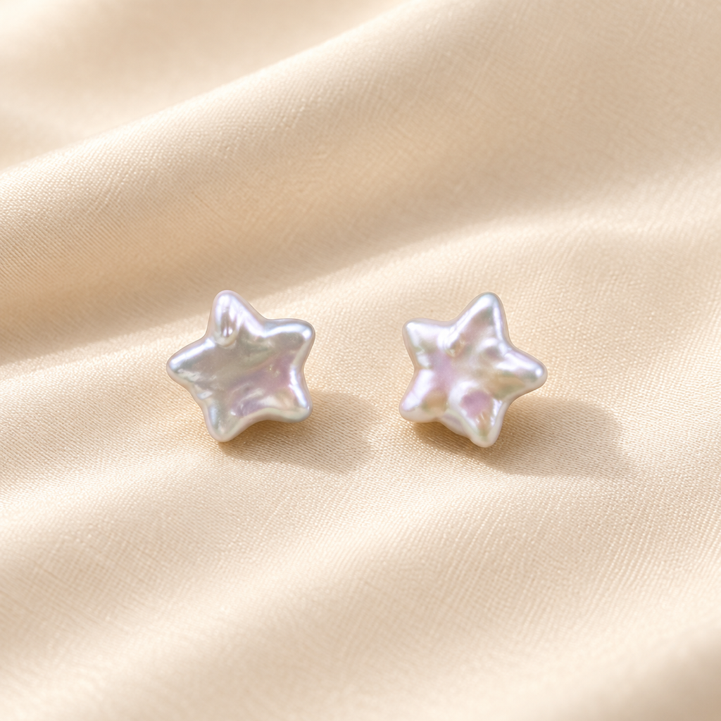 VEEKISSY celestial star pearl stud earrings, pair on ivory fabric