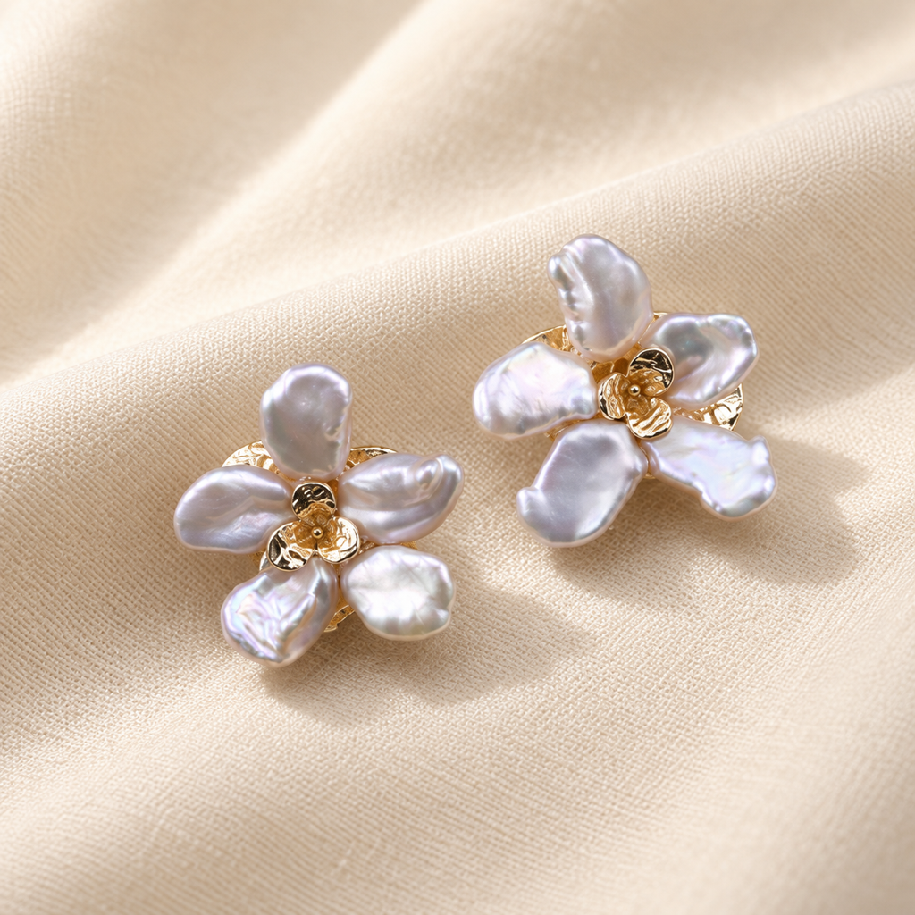 VEEKISSY floral baroque pearl stud earrings, alternative pair angle on cream fabric
