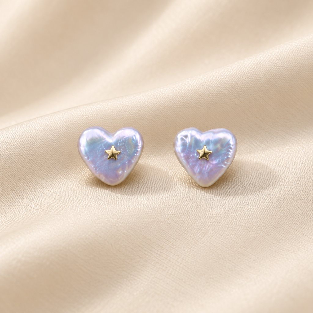 VEEKISSY heart-shaped baroque pearl stud earrings with gold stars, pair on ivory fabric